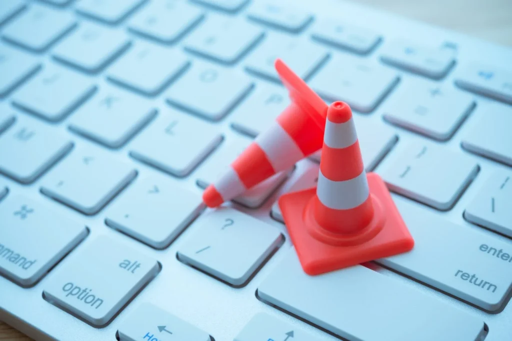 Maintenance, repair, under construction in computer system from virus or ransomware concept. Close up orange white traffic
